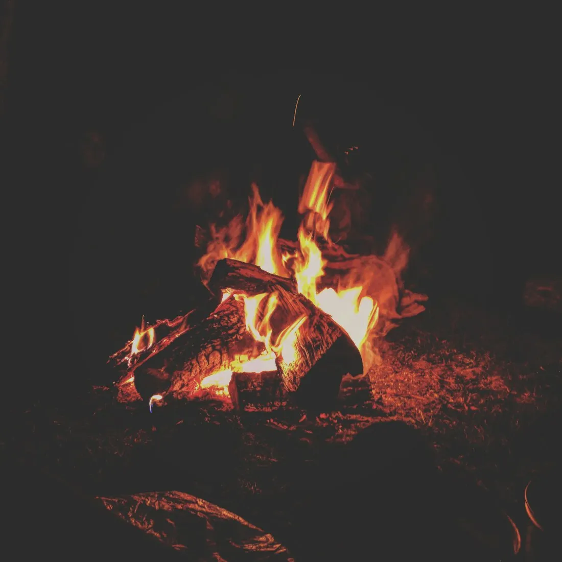 A campfire glowing at night